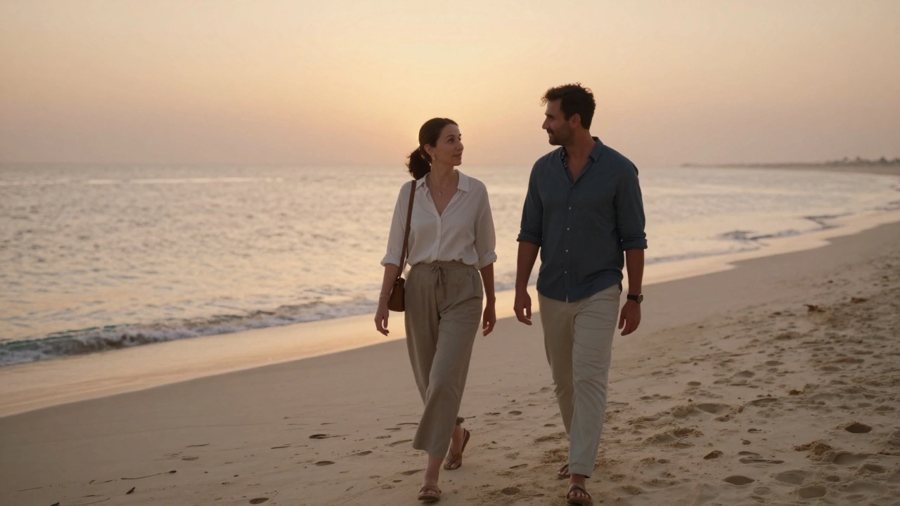 A woman and man walk peacefully along a Dubai beach at sunset, enjoying quiet companionship.